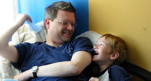 father and son laughing