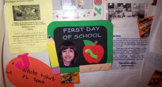 child's school work displayed on refrigerator