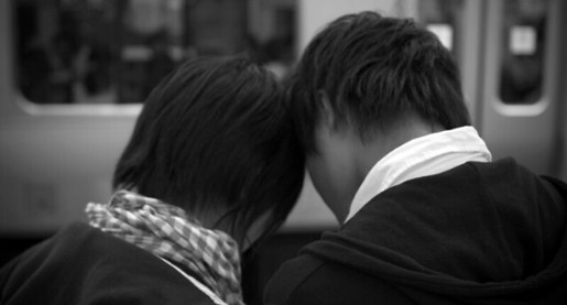 couple with heads together, bowed, and facing away
