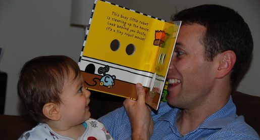 man reading a book to a child
