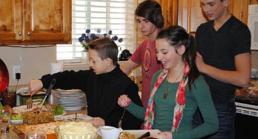 teens serving themselves food in the kitchen