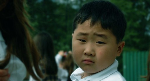 young asian boy looking at camera
